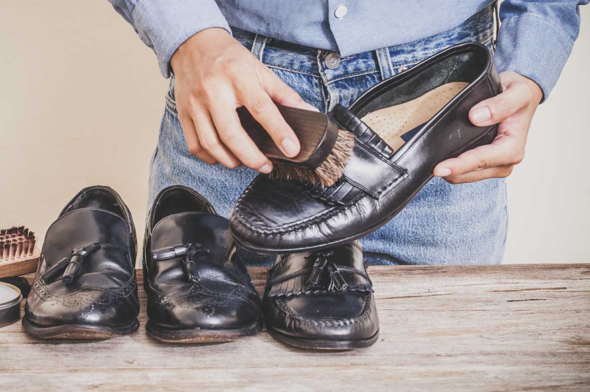 Hombre limpiando zapatos de piel